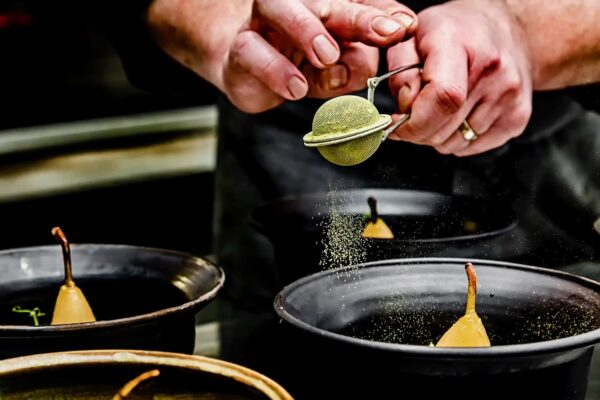 Praf de echilibru Pară fiartă în vin cu mirodenii, păstrând dulceața și profunzimea condimentelor. La bază, crema de mascarpone cu cafea aduce rotunjime și o notă discretă de amăreală. Pudra de matcha completează cu un contrast vegetal fin, într-un echilibru delicat între cald și proaspăt.